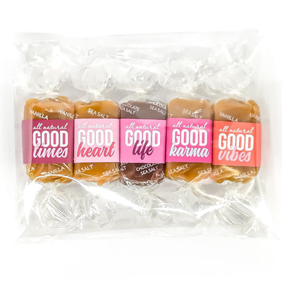 All-natural kosher caramel candy favor bags for event gifts.  Five carmels with varying shades of pink wrappers that say "Good Times" "Good Heart" "Good Life" "Good Karma" and "Good Vibes"