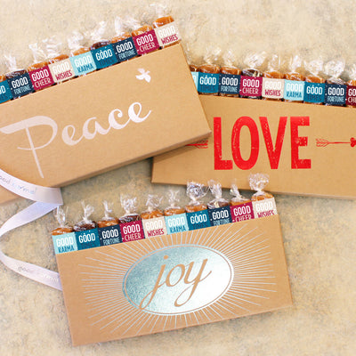 Three 10-piece Caramel Gift Boxes, each printed with a different message of Peace, Love, and Joy.