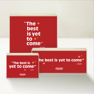 Three holiday-themed Good Karmal caramel gift boxes with red backgrounds and gold stars that say "The best is yet to come - 2025."