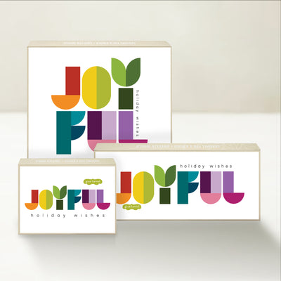 Three holiday-themed Good Karmal caramel gift boxes sharing joyful holiday wishes in cheerful lettering. 