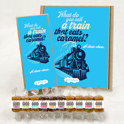 Good Karmal caramel gift box featuring an illustrated steam engine train against a bright blue background that says "Happy Father's Day" and the dad joke, "What do you call a train that eats caramel? A chew-chew." Caramels shown are wrapped in the positive words, Good Times; Good Fortune; Good Quotes; Good Karma; and Good Vibes. Sea salt, Chocolate Sea Salt and Vanilla caramels.
