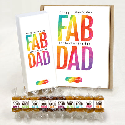 Good Karmal caramel gift box featuring rainbow lettering that says "Happy Father's Day" and "FAB DAD. The fabbest of the fab." Caramels shown are wrapped in the positive words, Good Times; Good Fortune; Good Quotes; Good Karma; and Good Vibes. Sea salt, Chocolate Sea Salt and Vanilla caramels.