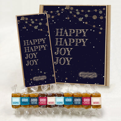 Multi-flavor caramel holiday gift box filled with caramels wrapped in positive quotes and good cheer, good wishes, good fortune, good times and good karma. The outside of the gift box says, "Happy Happy Joy Joy." These are Good Karmal's holiday caramels.