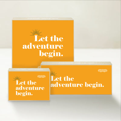 Three Good Karmal caramel gift boxes that say "Let the adventure begin!" on a colorful background.