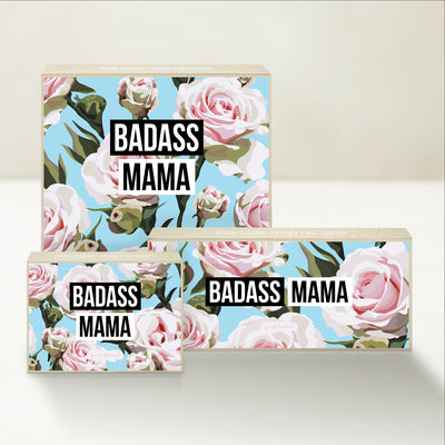 Three Good Karmal caramel gift boxes that say "Badass Mama" on a bold floral background.