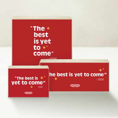 Three holiday-themed Good Karmal caramel gift boxes with red backgrounds and gold stars that say "The best is yet to come - 2026."