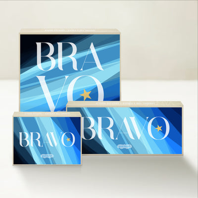 Three Good Karmal caramel gift boxes that say "bravo" on a bright, spotlight dappled background.