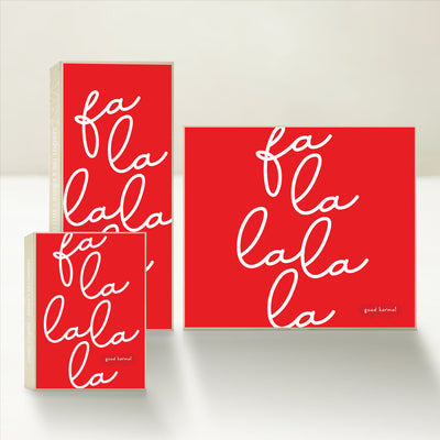 Three holiday-themed Good Karmal caramel gift boxes featuring whimsical "fa-la-la-la-la" script.