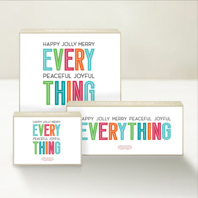 Three holiday-themed Good Karmal caramel gift boxes featuring playful "happy everything" holiday wishes. 