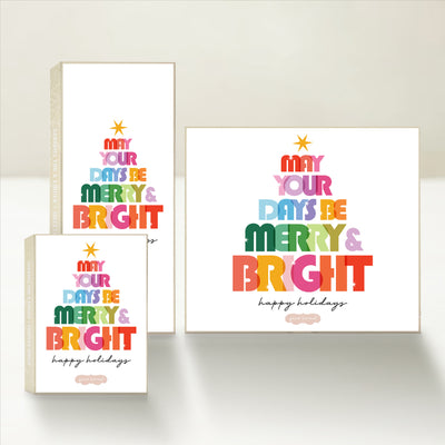 Three Good Karmal caramel gift boxes featuring colorful text that says "may your days be merry & bright" with happy holiday wishes.