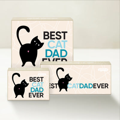 Three Good Karmal caramel gift boxes that say "Best Cat Dad Ever" with a whimsical illustration of a cat.