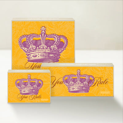 Three Good Karmal caramel gift boxes that say "You Rule" with a whimsical illustration of a crown with the word Queen on it. 