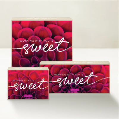 Three Good Karmal caramel gift boxes that say "Working with you is sweet" on a vibrant background.